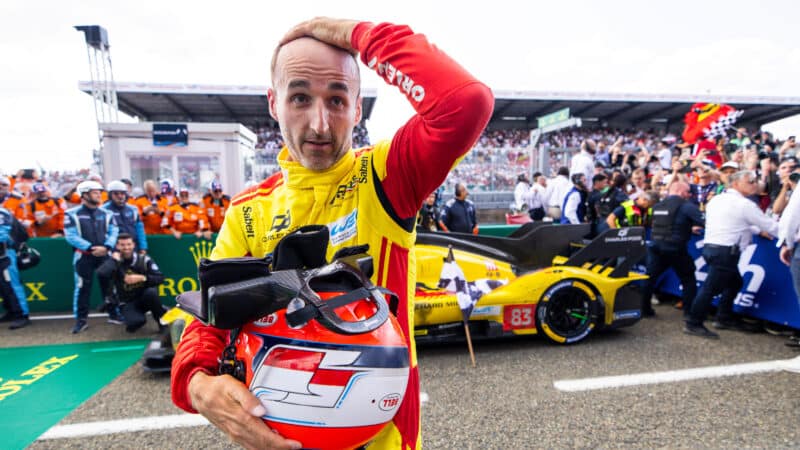 Robert Kubica holds his head after winning the 2025 Le Mans 24 Hours race